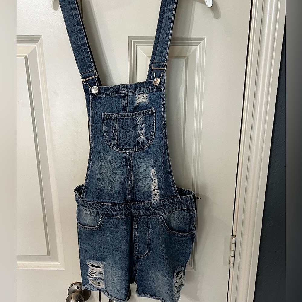 Distressed denim shortalls.